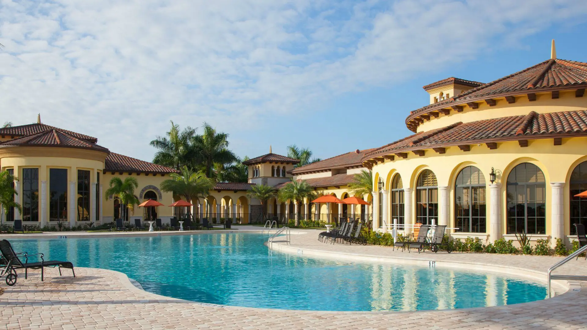 A large swimming pool with chairs around it