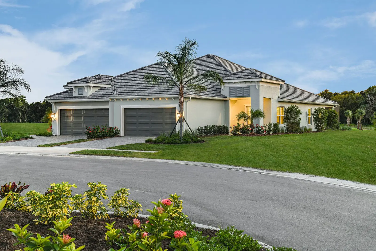 A large white house with a driveway in front of it.