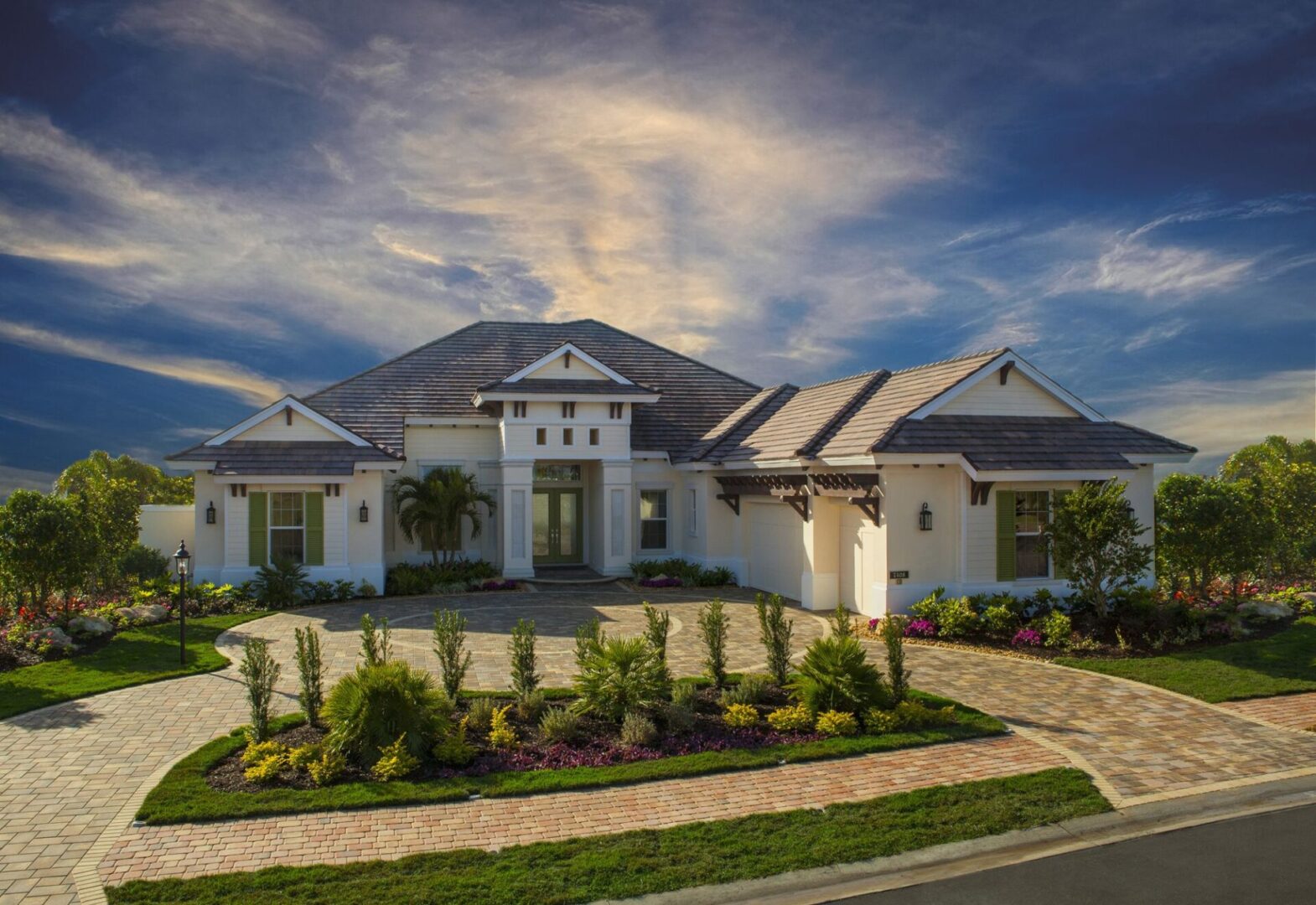 A large white house with a lush green lawn.